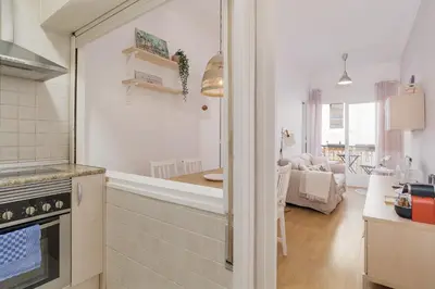a kitchen and living room with a counter and a stove at Stylish Apartment In Gracia in Barcelona