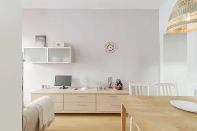 a white room with a desk with a computer on it at Stylish Apartment In Gracia in Barcelona
