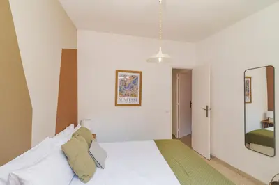 a bedroom with a white bed and a mirror at Amazing Terrace In Sant Andreu in Barcelona