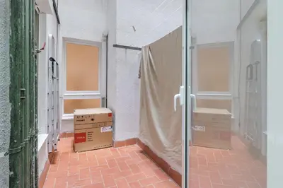 two boxes in an empty hallway with windows at Amazing Terrace In Sant Andreu in Barcelona