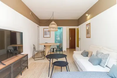 a living room with a couch and a table at Amazing Terrace In Sant Andreu in Barcelona
