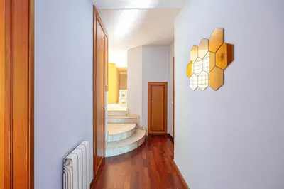 a hallway with some stairs and a mirror at Bright Attic & Amazing Terrace in Hospitalet de Llobregat