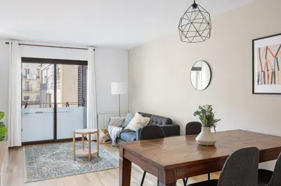 a living room with a table and a couch at Lovely&cozy In Born in Barcelona