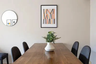 a dining room with a table with a vase on it at Lovely&cozy In Born in Barcelona