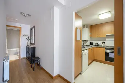 a kitchen with wooden cabinets and white appliances at Lovely&cozy In Born in Barcelona