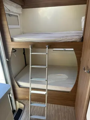 a small room with a bunk bed and a ladder at Rent&Road in Caldes de Montbui