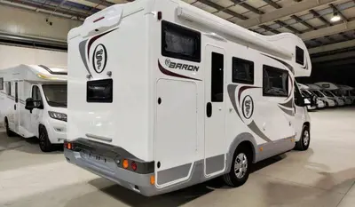 a white rv is parked in a garage at Rent&Road in Caldes de Montbui