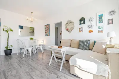 a living room with a couch and a table at Hauzify I Apartament Zulú Cubelles in Cubelles