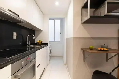 a kitchen with a sink and a counter at Canela Homes BARCELONA URQUINAONA in Barcelona