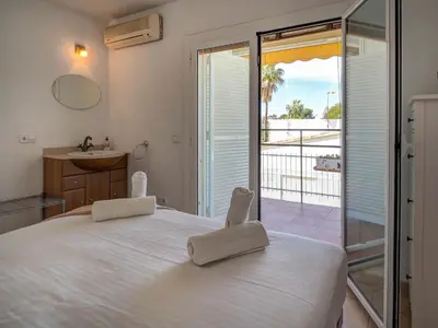 a bedroom with a bed and a view of the ocean at Arlene apartment by Hello Homes Sitges in Sitges