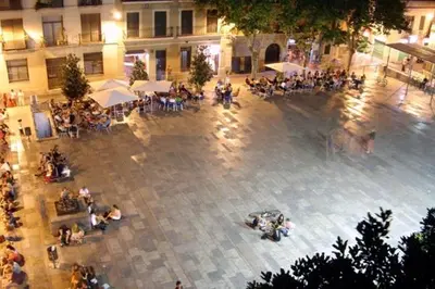 a group of people sitting around a courtyard at Barcelona Classic Gracia Apartments in Barcelona