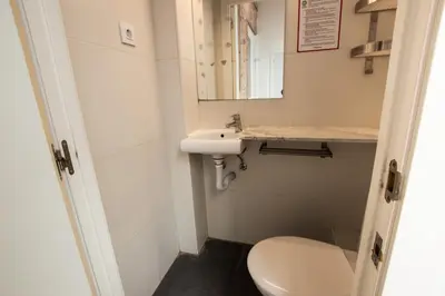 a small bathroom with a toilet and a sink at Barcelona Classic Gracia Apartments in Barcelona