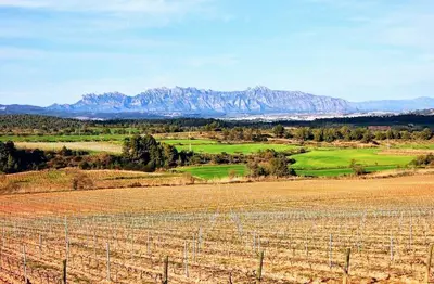 a field with a fence and mountains in the background at Habitación y Baño Privado, Tranquilidad y Naturaleza. in Barcelona