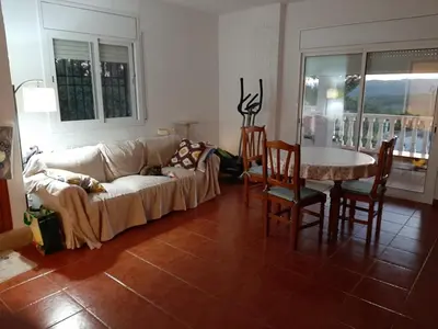 a living room with a couch and a table and chairs at Habitación y Baño Privado, Tranquilidad y Naturaleza. in Barcelona
