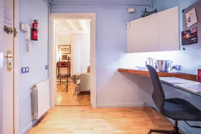 a kitchen with a desk and a chair in a room at EL BORN - Barcelona - Port 5 pax 2 bedrooms in Barcelona