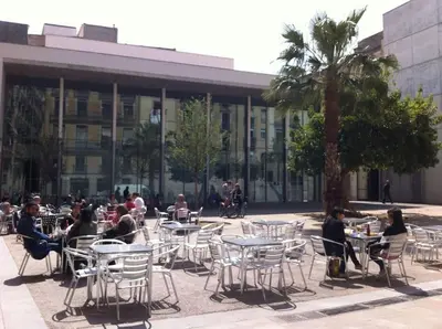 a group of people sitting at tables in front of a building at EL BORN - Barcelona - Port 5 pax 2 bedrooms in Barcelona