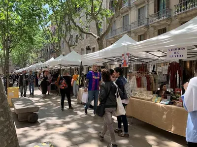 a group of people walking around a market with tents at EL BORN - Barcelona - Port 5 pax 2 bedrooms in Barcelona