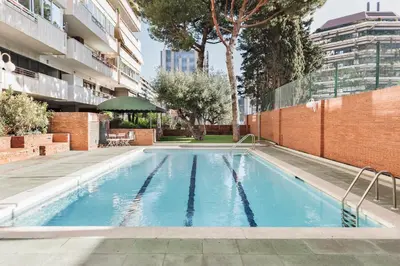 a swimming pool in the middle of a building at Aiguablava - 1 bedroom and pool in Pedralbes in Barcelona