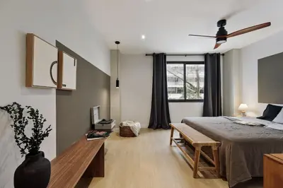 a dining room with a table with a vase on it at Aiguablava - 1 bedroom and pool in Pedralbes in Barcelona