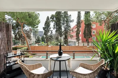 a living room with white walls and a wooden counter at Aiguablava - 1 bedroom and pool in Pedralbes in Barcelona