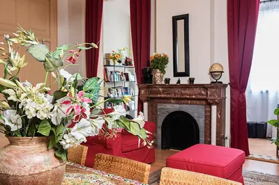 a living room with a fireplace and a red couch at Fashion House in Barcelona