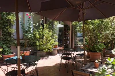 an outdoor patio with tables and chairs and plants at Fashion House in Barcelona