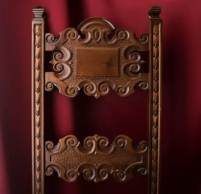 an ornate gold picture frame on a red wall at Fashion House in Barcelona
