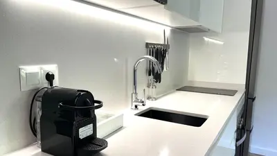 a white kitchen with a sink and a sink at CENTRO CON TERRAZA NGRO BY PRESTIGI in Terrassa