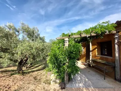 an outside view of a building with trees at CA L'ESTADANT in Abrera