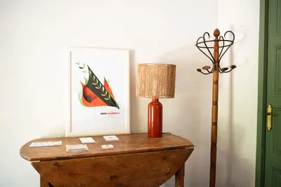 a table with a lamp and a picture on it at CA L'ESTADANT in Abrera