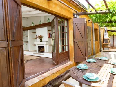 a patio with a table and an open door at CA L'ESTADANT in Abrera