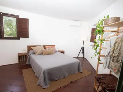a bedroom with a bed in a white room at CA L'ESTADANT in Abrera