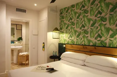 a bedroom with a bed with a green wall at Chic & Basic Lemon Boutique Hotel in Barcelona
