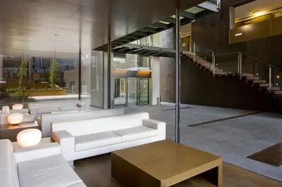 a living room with a white couch and a table at Holiday Inn Express Barcelona City 22@ by IHG in Barcelona