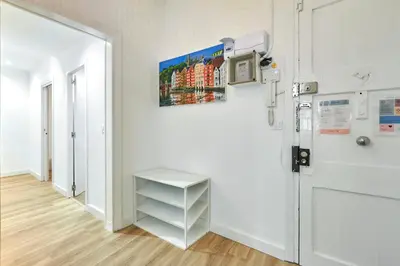 a white room with a door and a shelf at Comfortable apartment next to Apolo theater in Barcelona