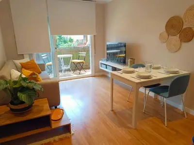 a living room with a table and a couch at Apartamento a 5' de la playa in Premiá de Mar