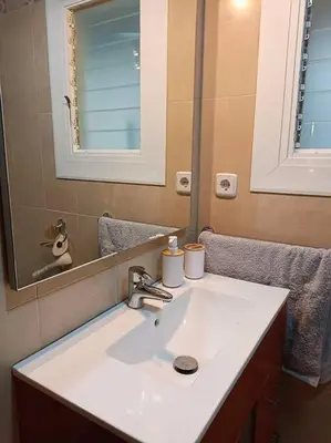 a bathroom with a white sink and a mirror at Apartamento a 5' de la playa in Premiá de Mar