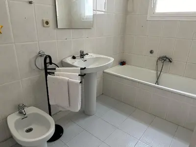 a bathroom with a sink and a toilet and a bath tub at Vista Alegre Rest House for 7 Persons in Vallromanas