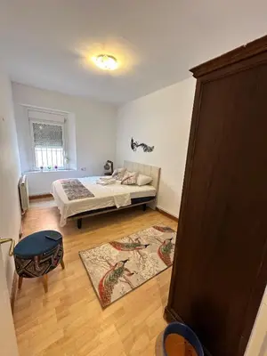 a bedroom with a bed and a room with a rug at Vista Alegre Rest House for 7 Persons in Vallromanas