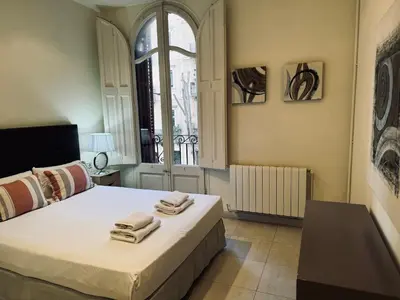 a bedroom with a bed with towels on it at Sweet BCN Borrell in Barcelona