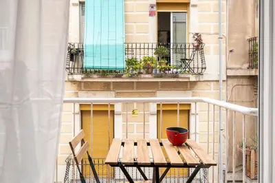 a wooden table with a pot on a balcony at Centric apartment Gràcia in Barcelona