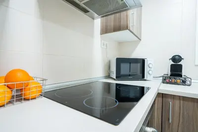 a kitchen with a sink and a microwave at Home365 · Barberá del Vallés · Barcelona in Barbera del Valles