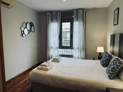 a bedroom with a large bed with towels on it at Sweet BCN Sagrada Familia in Barcelona