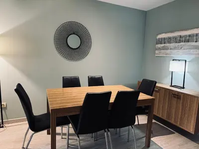 a dining room with a wooden table and black chairs at Sweet BCN Sagrada Familia in Barcelona