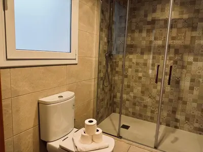 a bathroom with a toilet and a glass shower at Sweet BCN Sagrada Familia in Barcelona