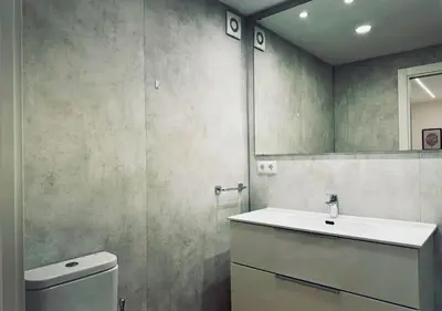 a bathroom with a sink and a toilet and a mirror at Sweet BCN Laforja in Barcelona