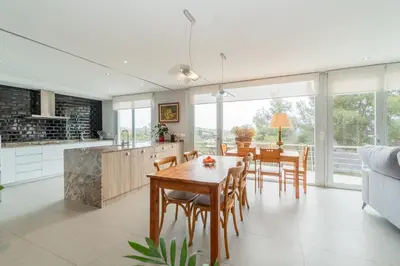 a kitchen and dining room with a table and chairs at Casa Majestic in Cunit