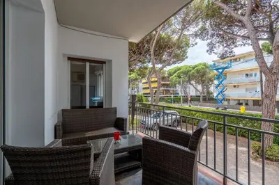 a balcony with chairs and a table with a view at Beachside Bliss in Castelldefels