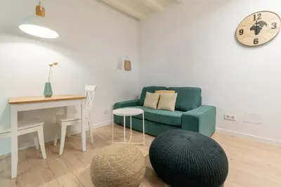 a living room with a green couch and a table at Amazing flat in Barceloneta with private terrace 2-2 in Barcelona
