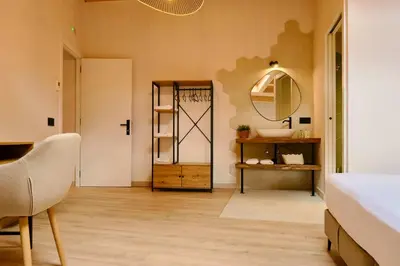 a bedroom with a bed and a mirror and a table at Hotel Molí Cardedeu in Cardedeu